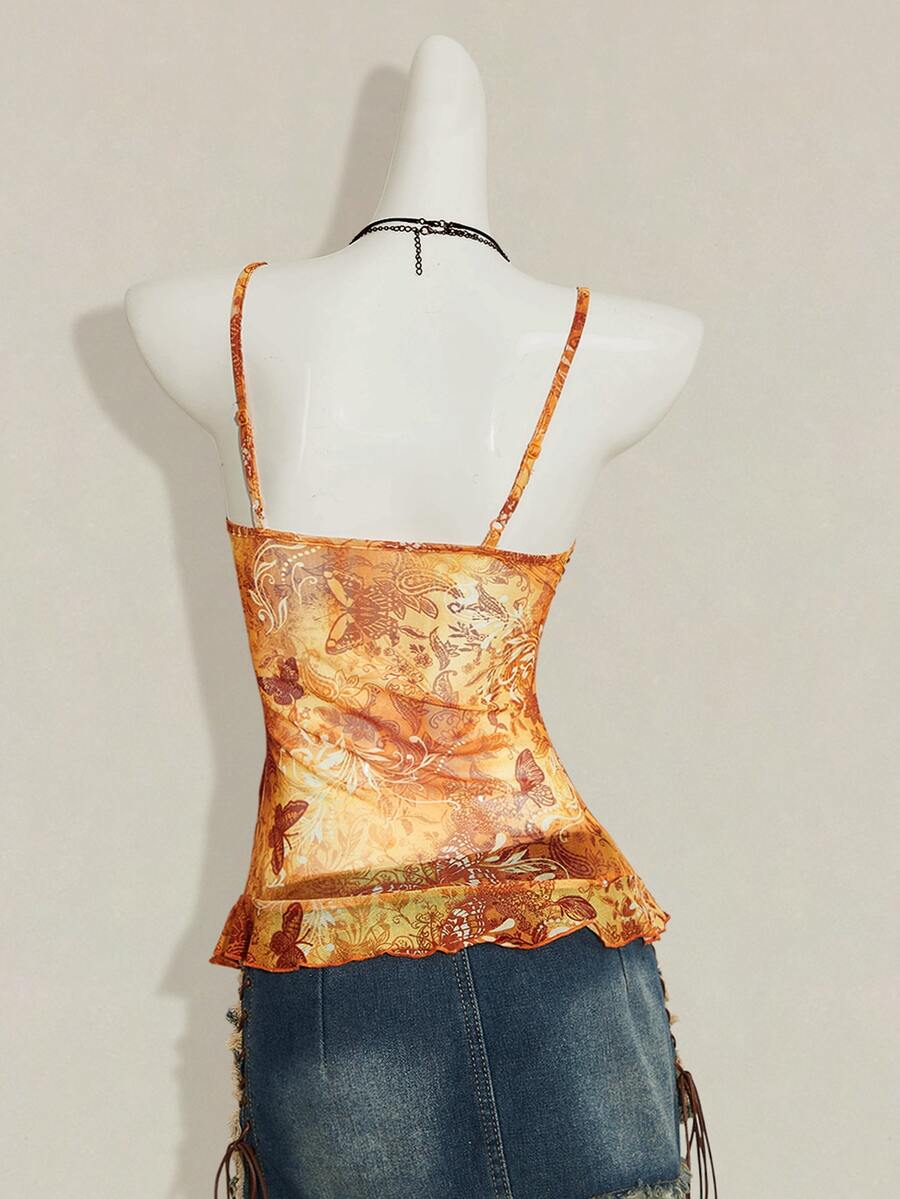 Women's burgundy floral graphic print mesh camisole top featuring an asymmetrical hem, backless cut, and spaghetti straps.