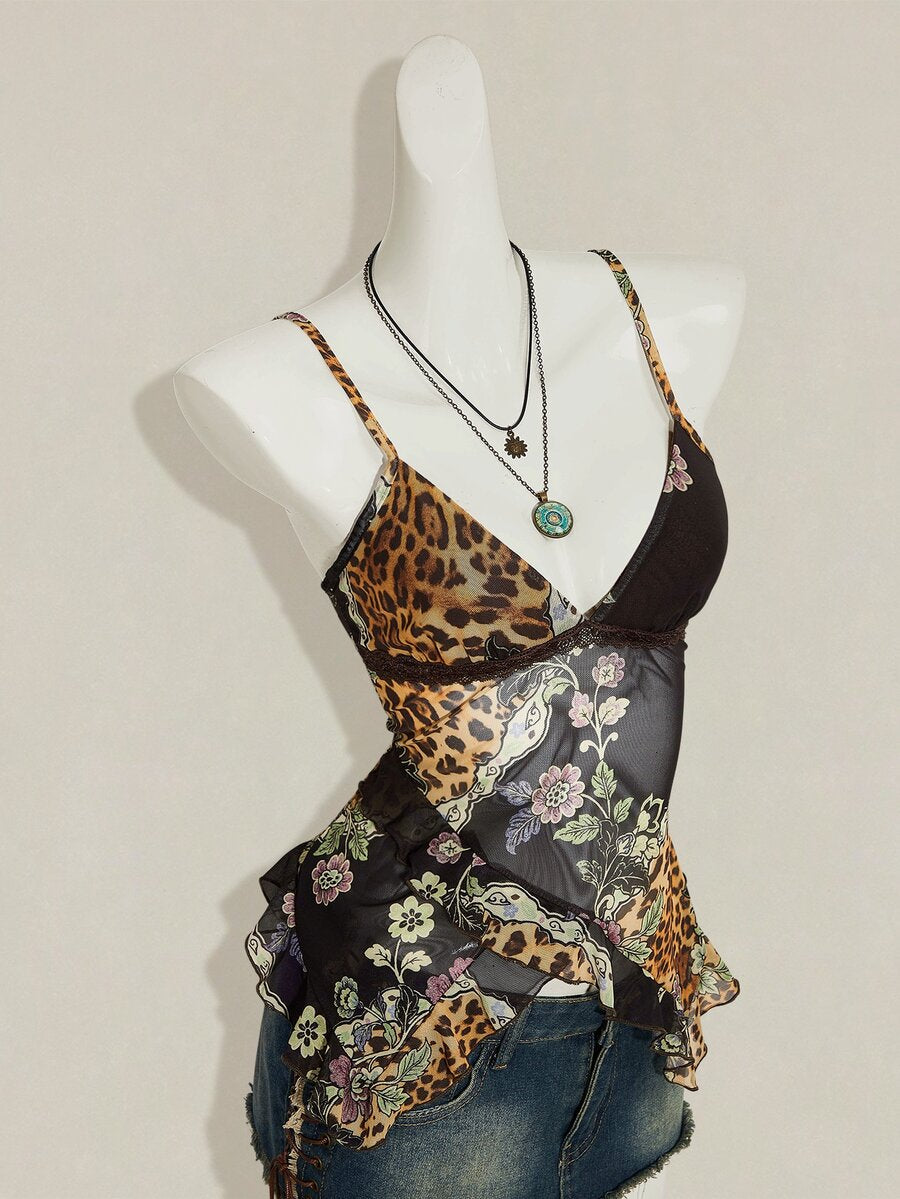 Women's burgundy floral graphic print mesh camisole top featuring an asymmetrical hem, backless cut, and spaghetti straps.