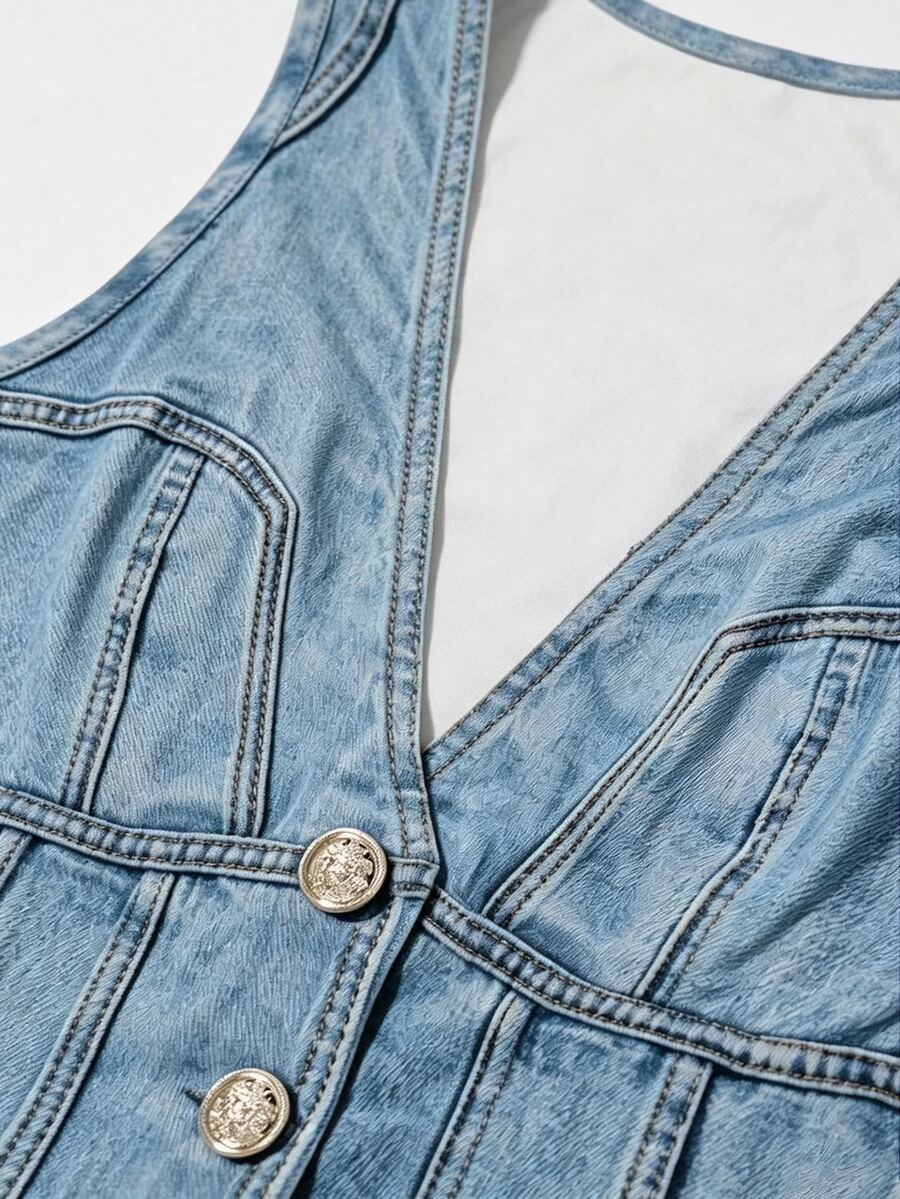 Woman wearing a blue denim print tank top featuring a button-front design, asymmetrical hem, and matching detached arm sleeves.