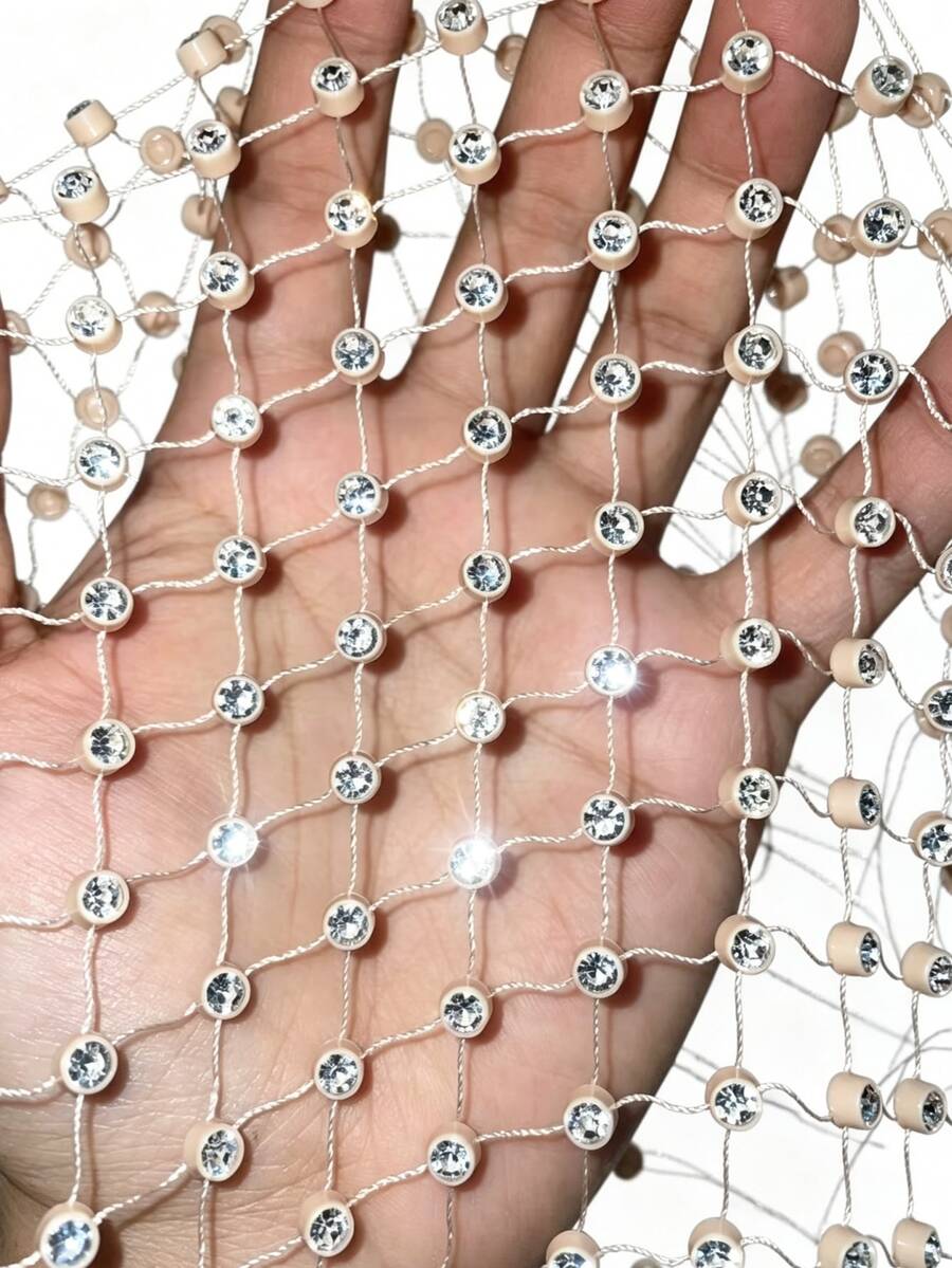 Black sheer mesh halter top for women featuring rhinestone glitter effect, backless design, chain details, and an asymmetrical hem.