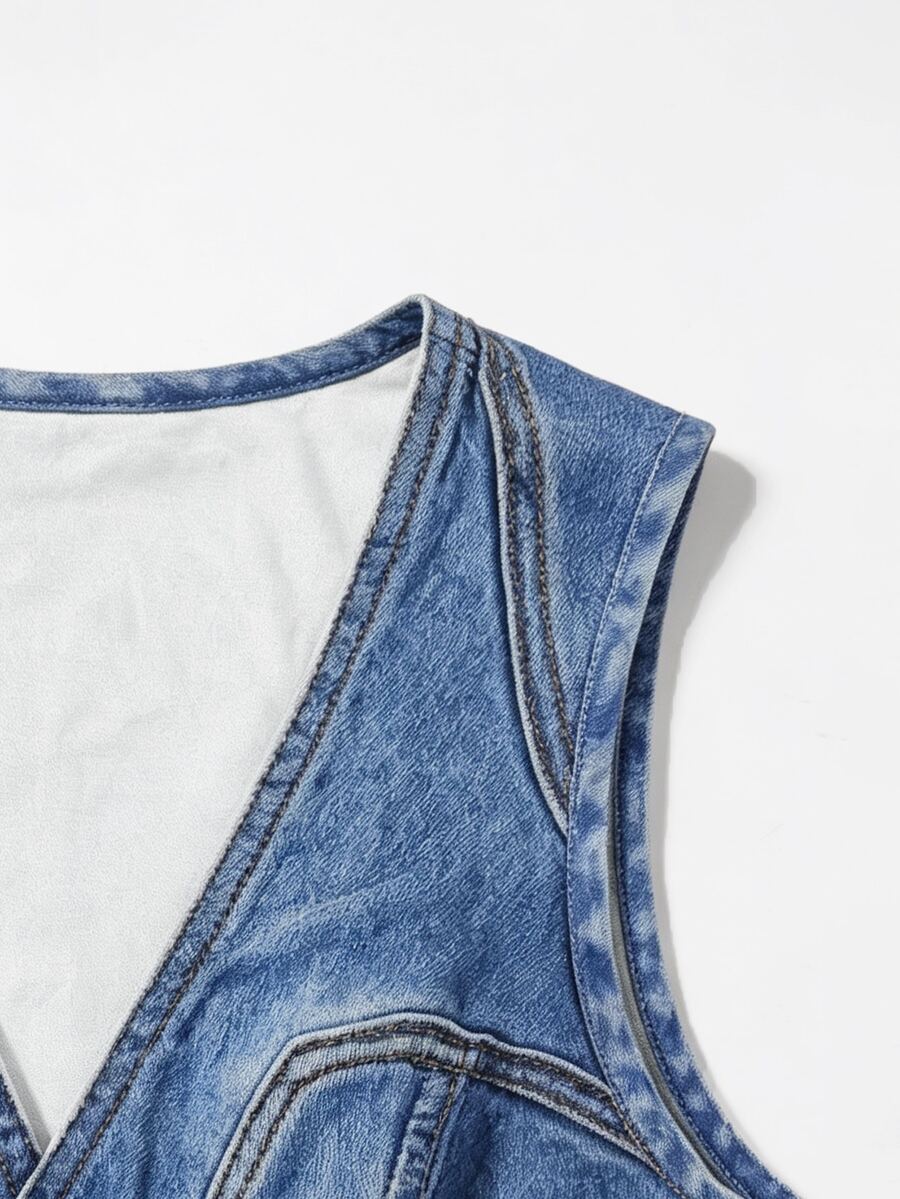 Woman wearing a blue denim print tank top featuring a button-front design, asymmetrical hem, and matching detached arm sleeves.