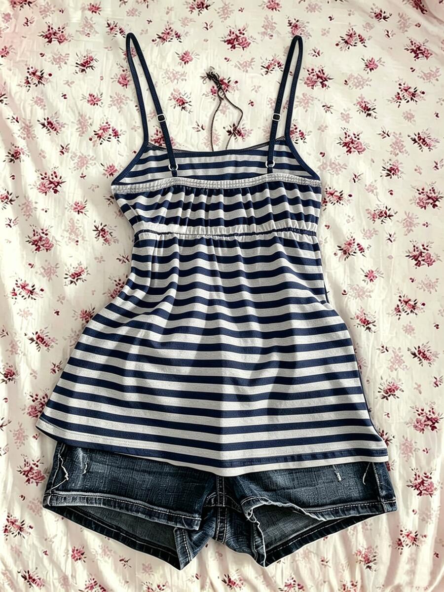 A women's black striped camisole top featuring spaghetti straps, a backless design with ring detail, and high-stretch knitted fabric.