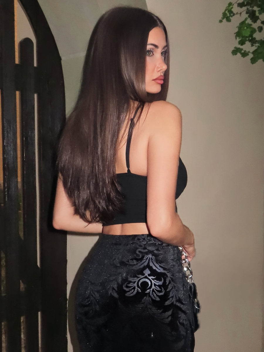 Black sleeveless crop cami top featuring a front lace-up tie design with grommet eyelets and slim spaghetti straps.