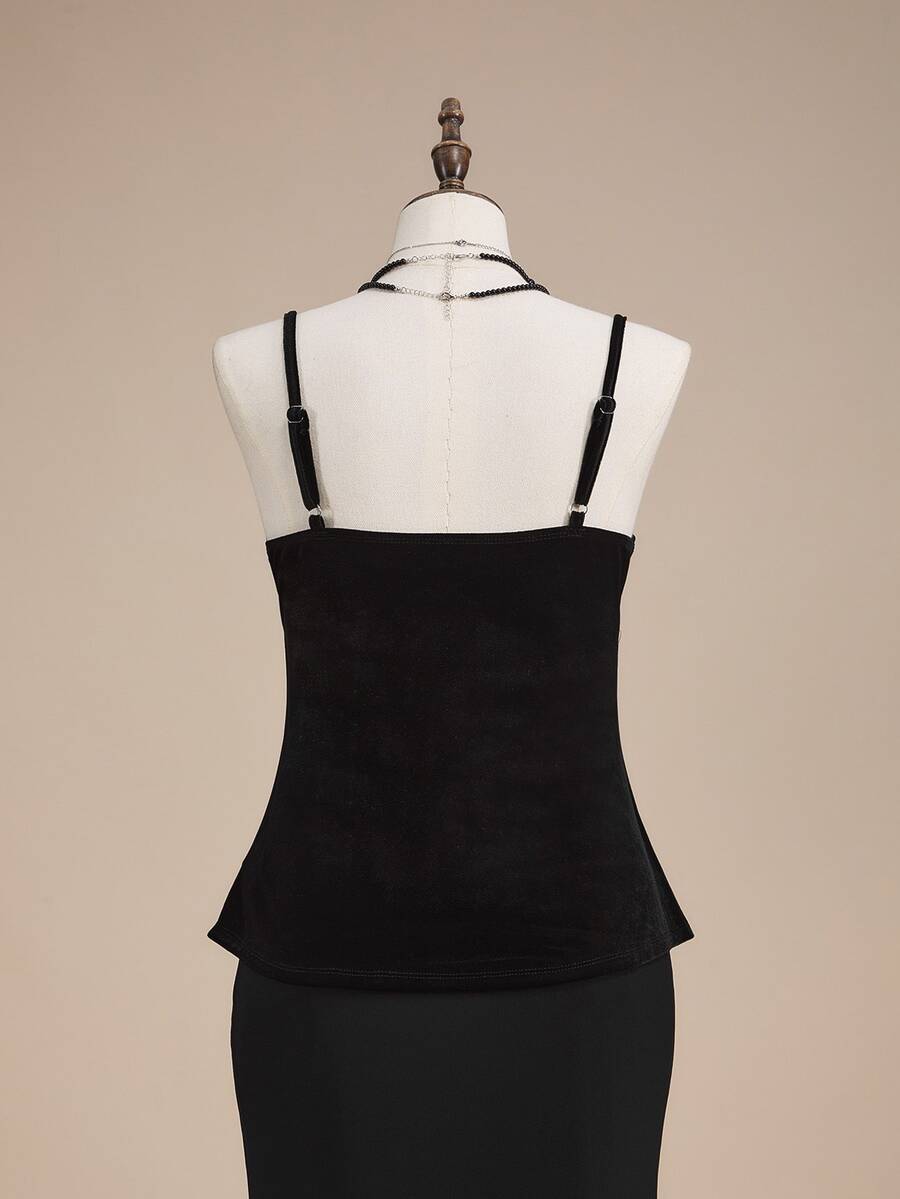Black velvet camisole top featuring an astrology moon and star graphic print, spaghetti straps, and a backless lace-up design.