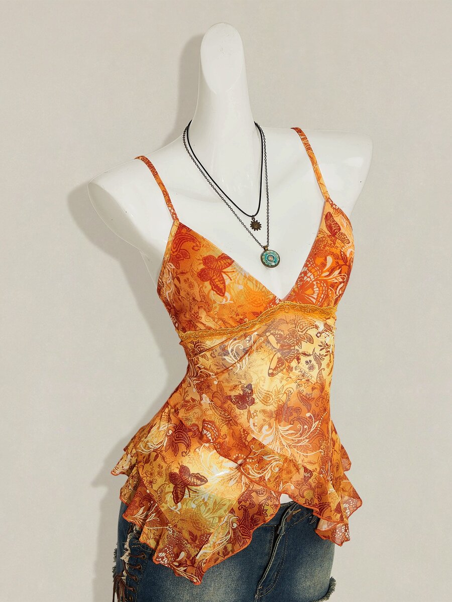 Women's burgundy floral graphic print mesh camisole top featuring an asymmetrical hem, backless cut, and spaghetti straps.