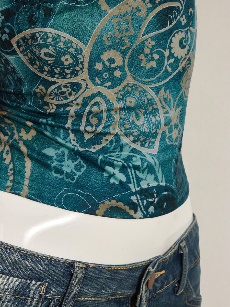 Women's blue fitted camisole top with contrast lace patchwork print, backless asymmetrical hem, and spaghetti straps.