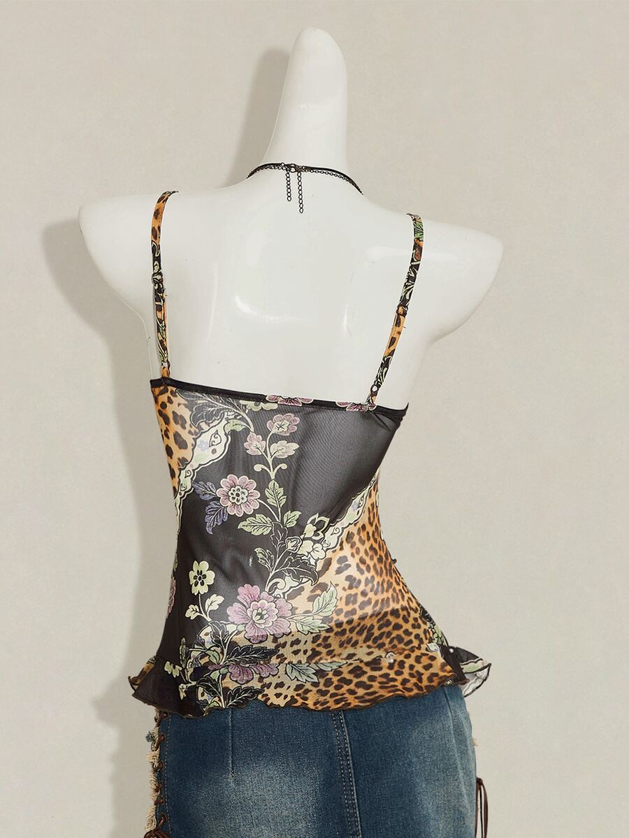 Women's burgundy floral graphic print mesh camisole top featuring an asymmetrical hem, backless cut, and spaghetti straps.