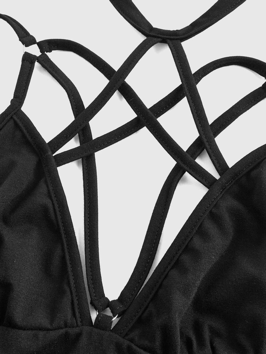 Front and back view of a women's black cut out criss cross crop tank top with spaghetti straps and a backless slim fit design.