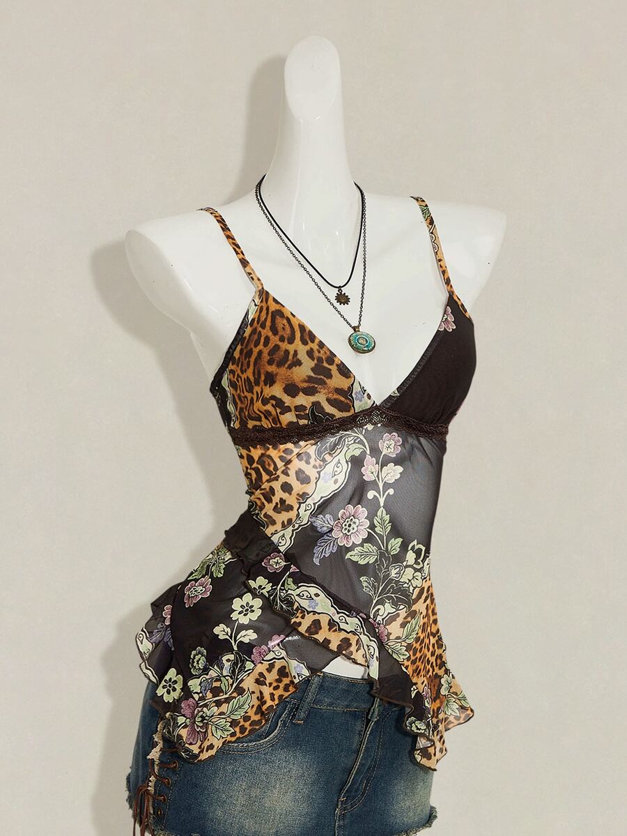 Women's burgundy floral graphic print mesh camisole top featuring an asymmetrical hem, backless cut, and spaghetti straps.