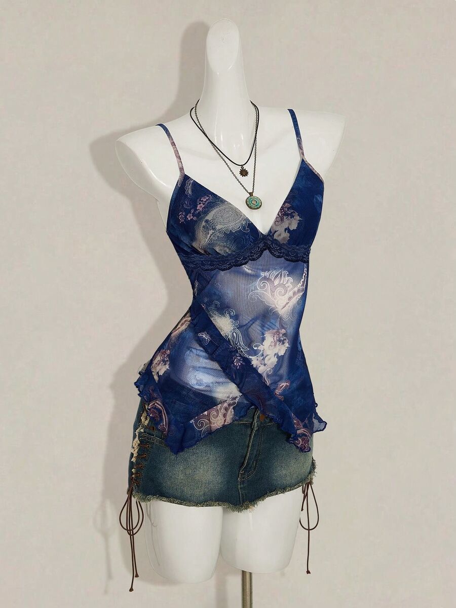 Women's burgundy floral graphic print mesh camisole top featuring an asymmetrical hem, backless cut, and spaghetti straps.