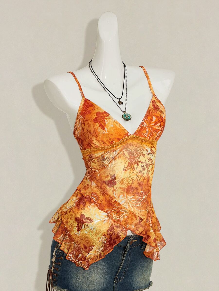 Women's burgundy floral graphic print mesh camisole top featuring an asymmetrical hem, backless cut, and spaghetti straps.