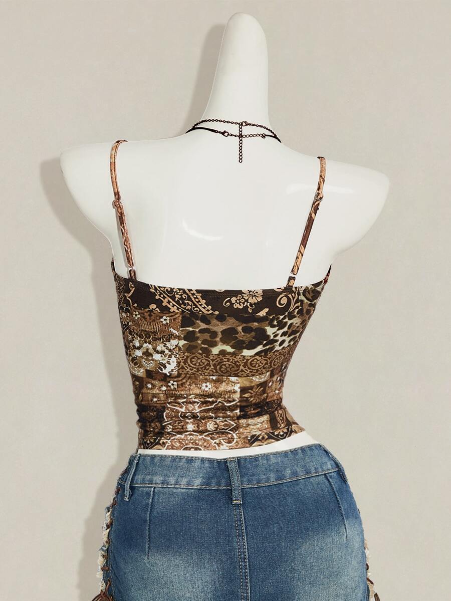 Women's blue fitted camisole top with contrast lace patchwork print, backless asymmetrical hem, and spaghetti straps.