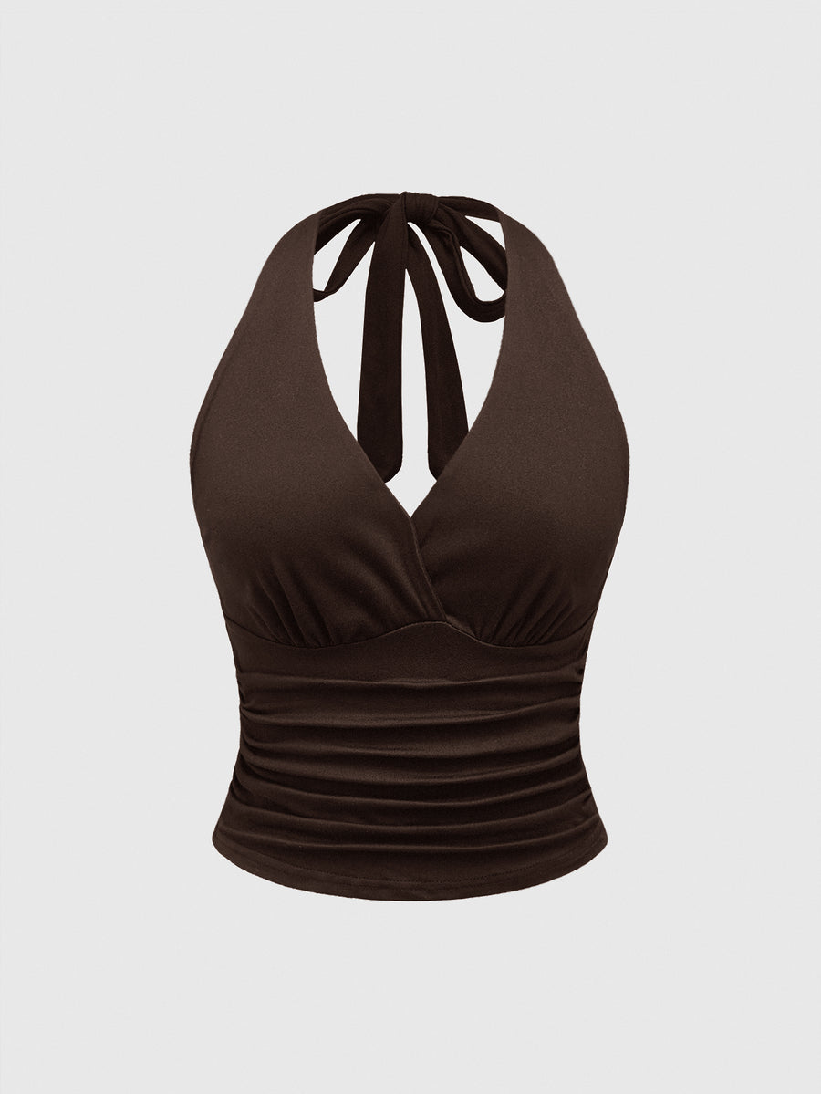 Women's halter crop tank top featuring a backless silhouette and ruched detailing in a slim fit design.