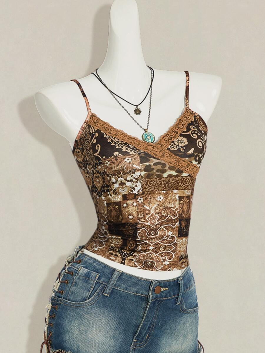 Women's blue fitted camisole top with contrast lace patchwork print, backless asymmetrical hem, and spaghetti straps.