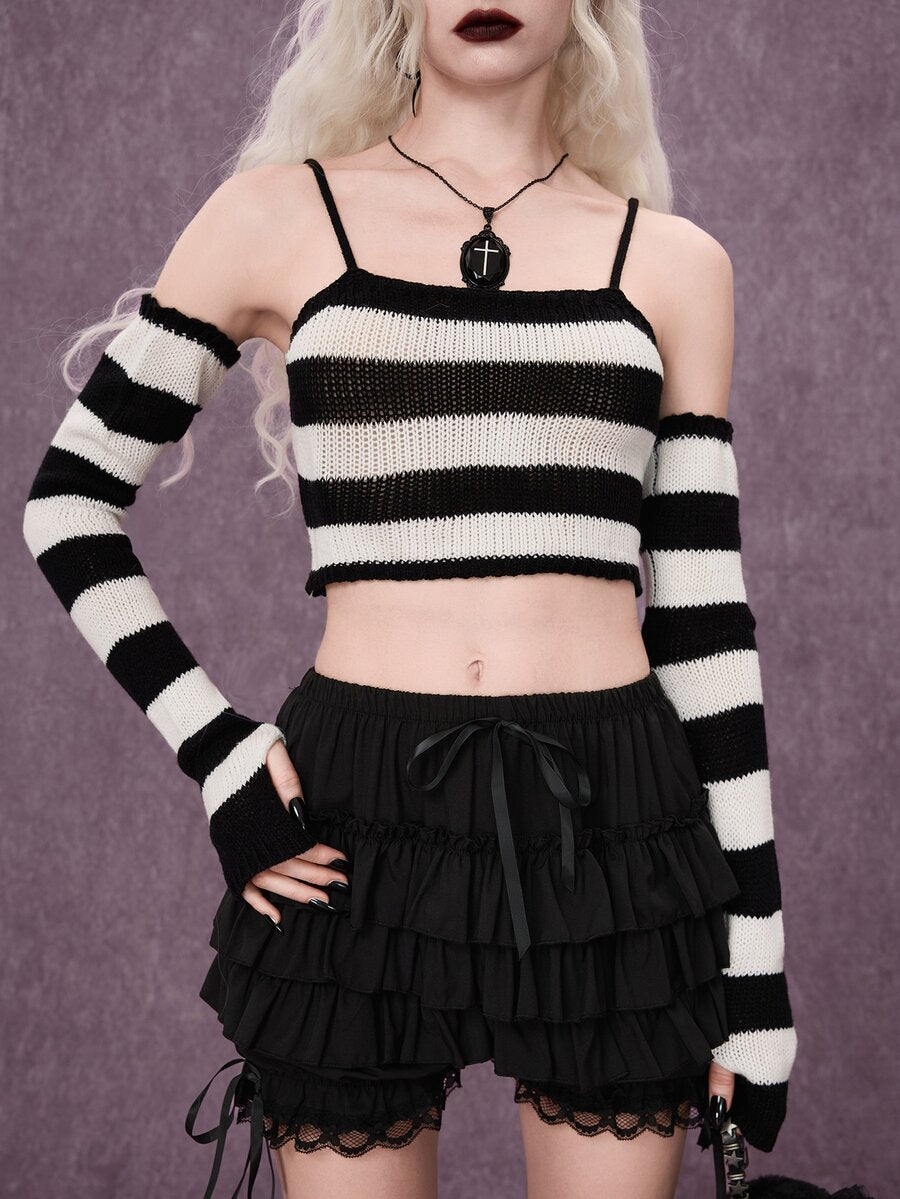 Women wearing a black and white striped camisole knit crop top with spaghetti straps and extra-long cold shoulder sleeves.