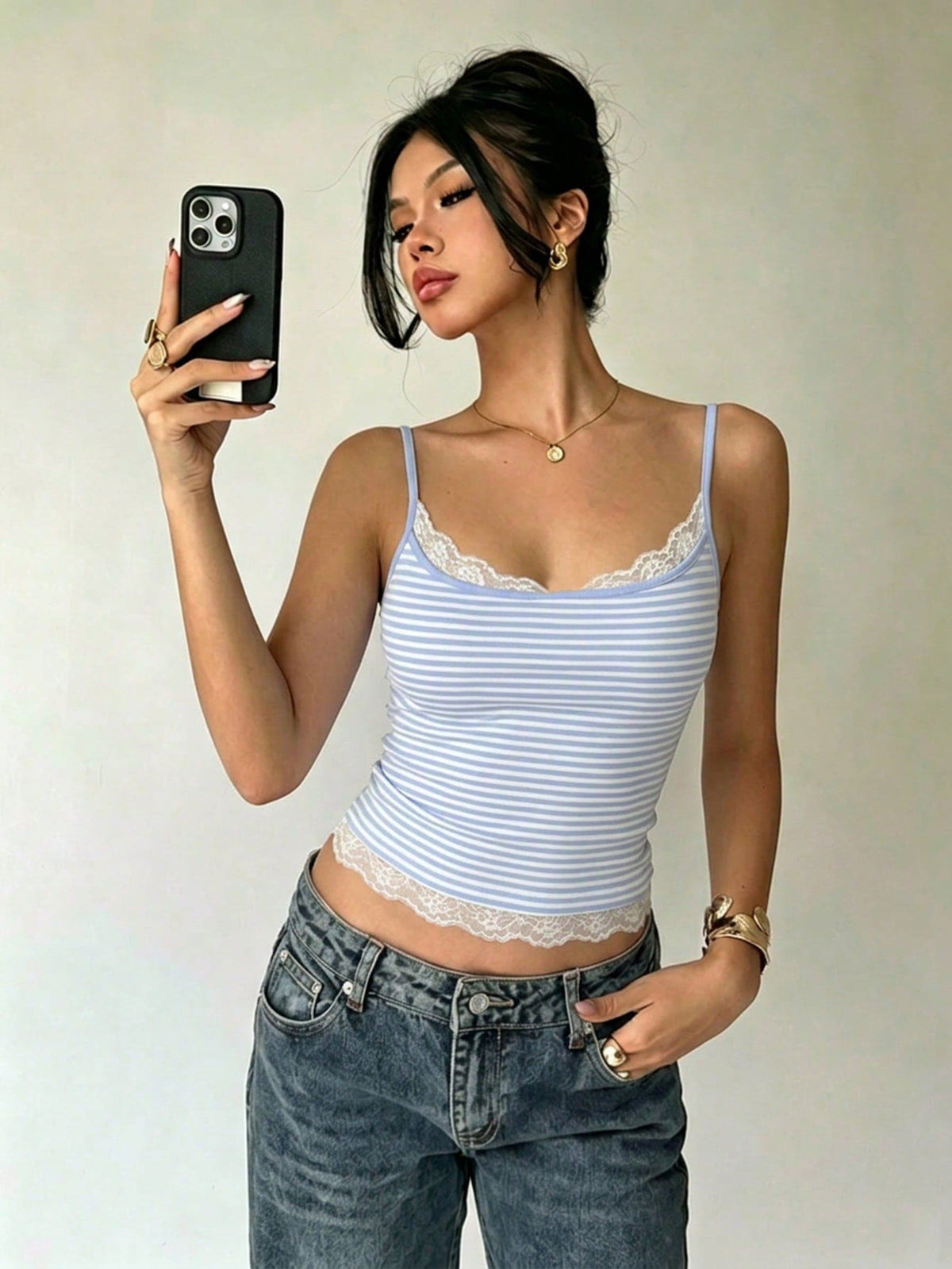 Women's blue and white striped camisole featuring white contrast lace patchwork, spaghetti straps, and a backless slim fit design.