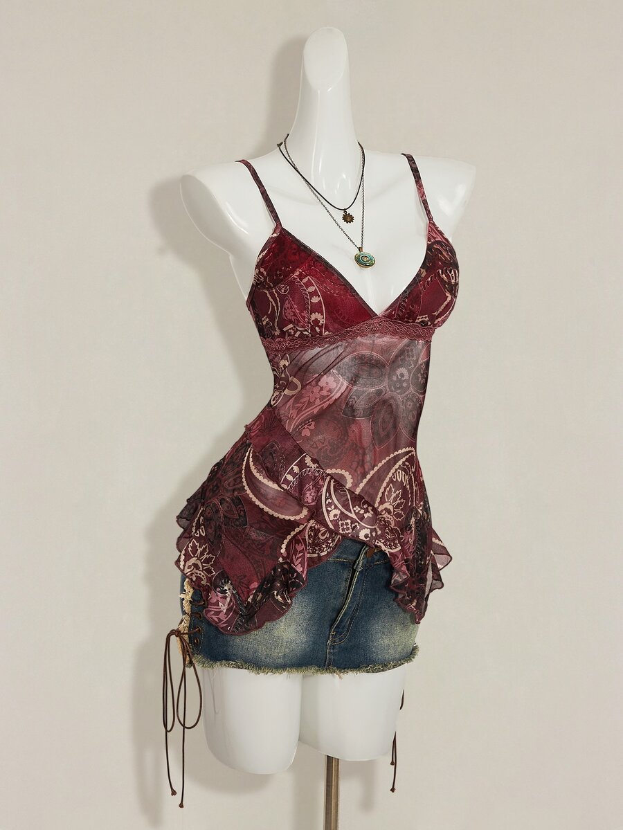 Women's burgundy floral graphic print mesh camisole top featuring an asymmetrical hem, backless cut, and spaghetti straps.