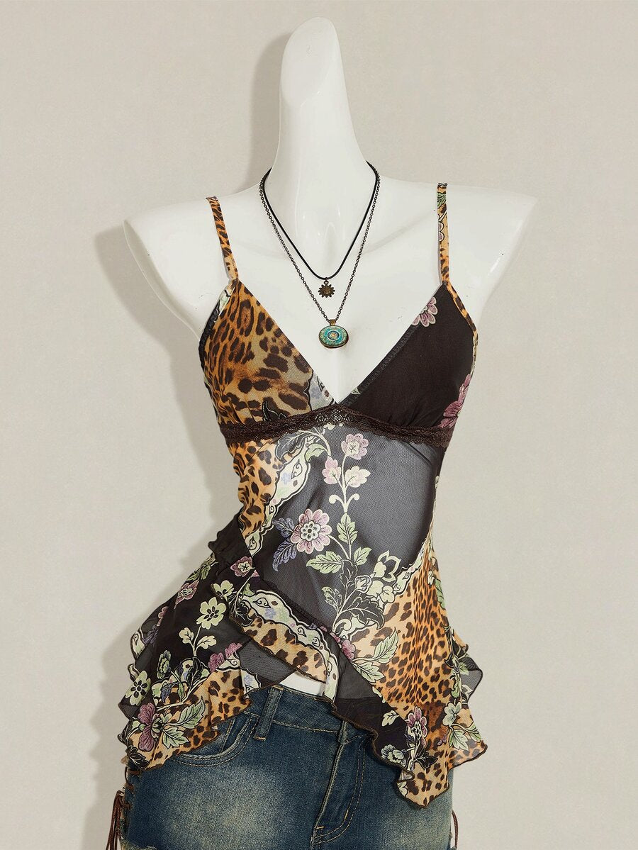 Women's burgundy floral graphic print mesh camisole top featuring an asymmetrical hem, backless cut, and spaghetti straps.