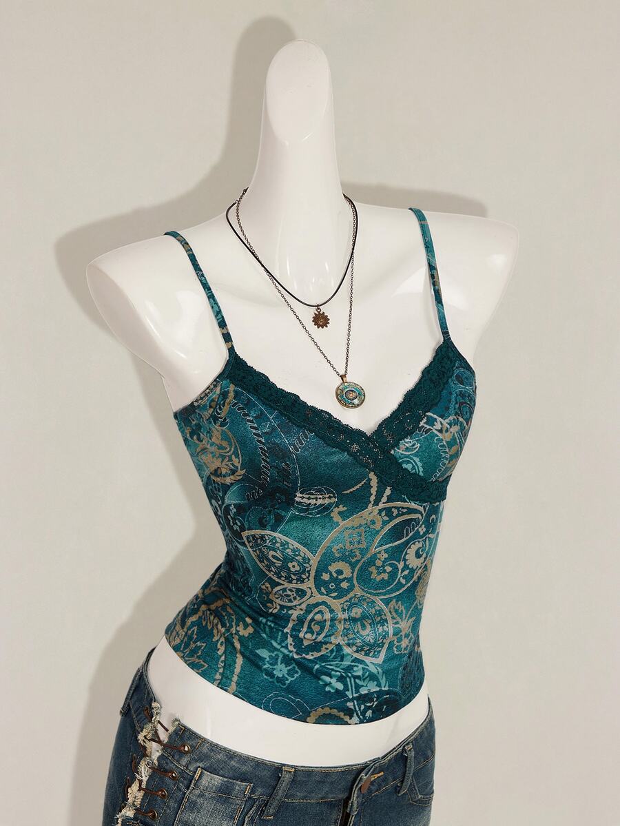 Women's blue fitted camisole top with contrast lace patchwork print, backless asymmetrical hem, and spaghetti straps.