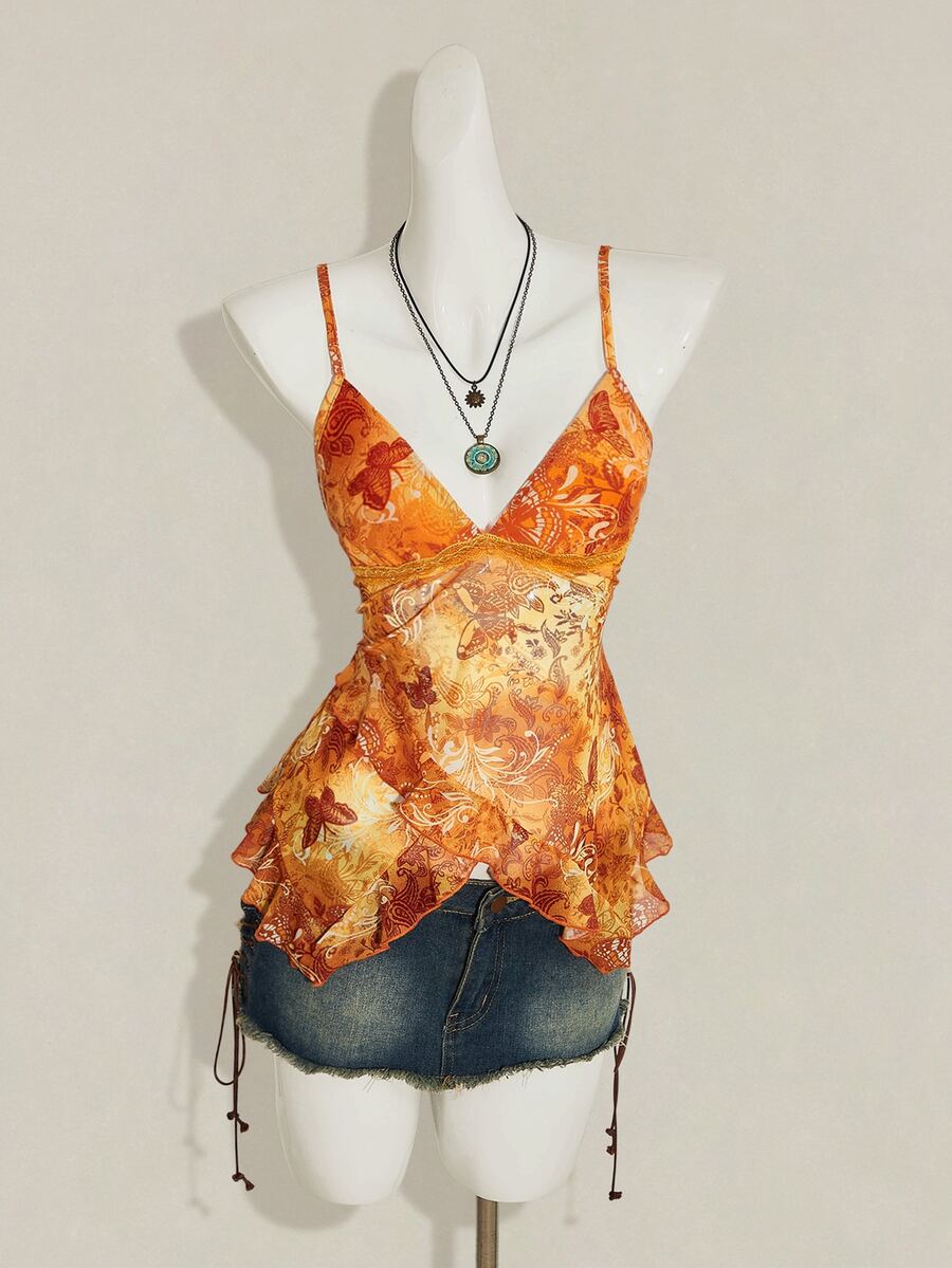 Women's burgundy floral graphic print mesh camisole top featuring an asymmetrical hem, backless cut, and spaghetti straps.