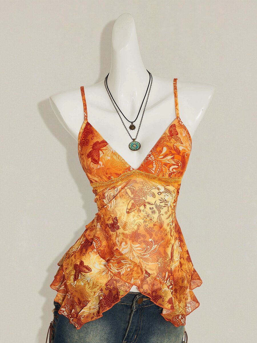 Women's burgundy floral graphic print mesh camisole top featuring an asymmetrical hem, backless cut, and spaghetti straps.