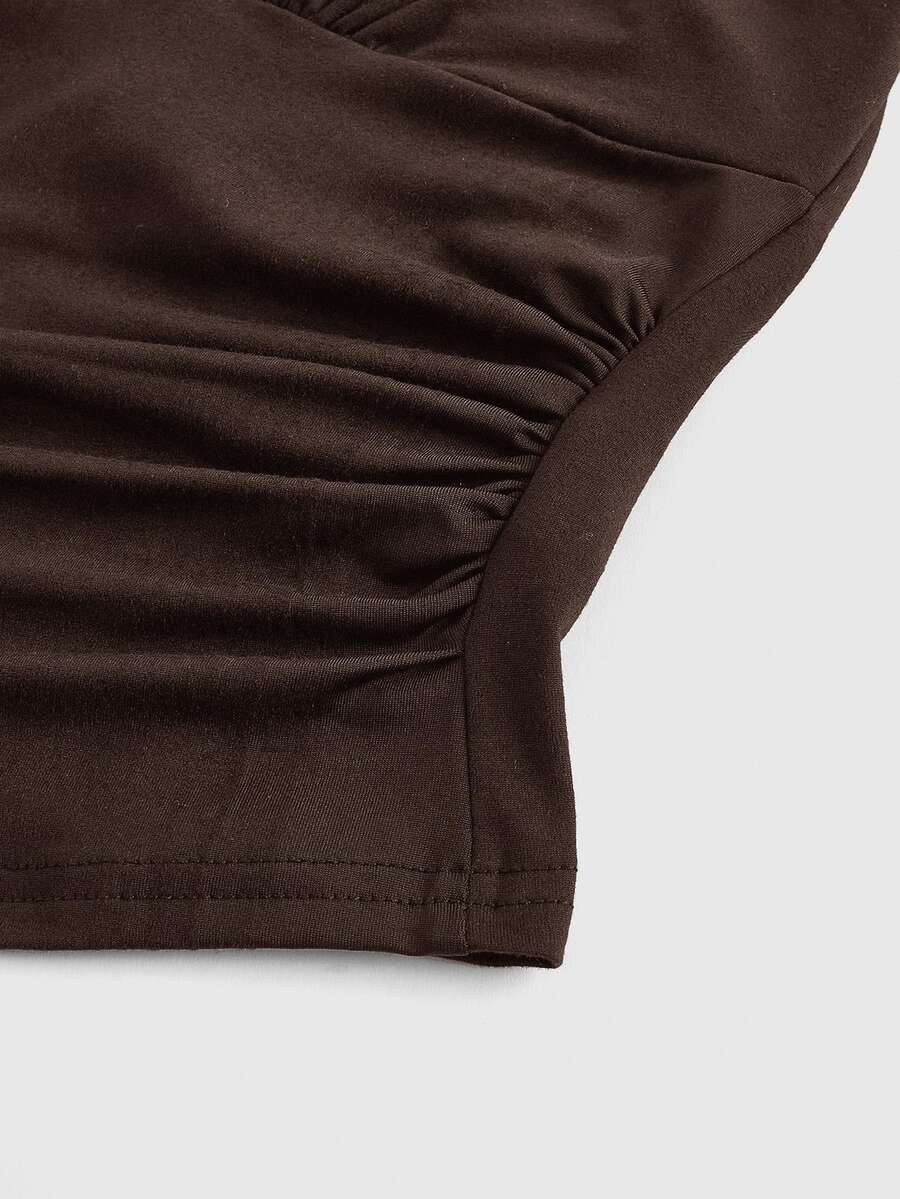 Women's halter crop tank top featuring a backless silhouette and ruched detailing in a slim fit design.