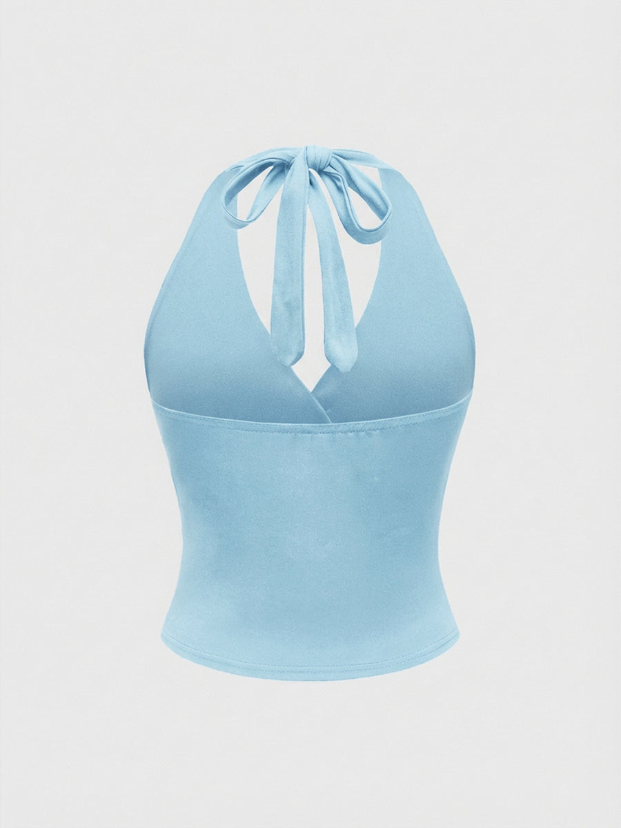 Women's halter crop tank top featuring a backless silhouette and ruched detailing in a slim fit design.