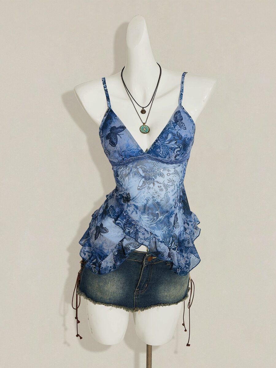 Women's burgundy floral graphic print mesh camisole top featuring an asymmetrical hem, backless cut, and spaghetti straps.