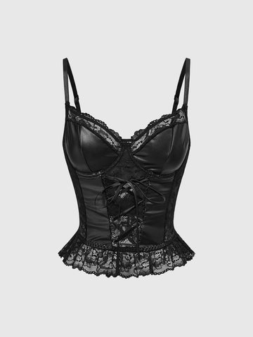 Woman wearing a black gothic micro crop camisole top featuring contrast lace trim, front lace-up detail, ruffle hem, and spaghetti straps.