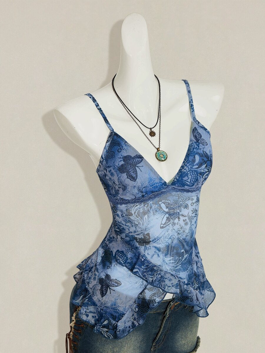 Women's burgundy floral graphic print mesh camisole top featuring an asymmetrical hem, backless cut, and spaghetti straps.