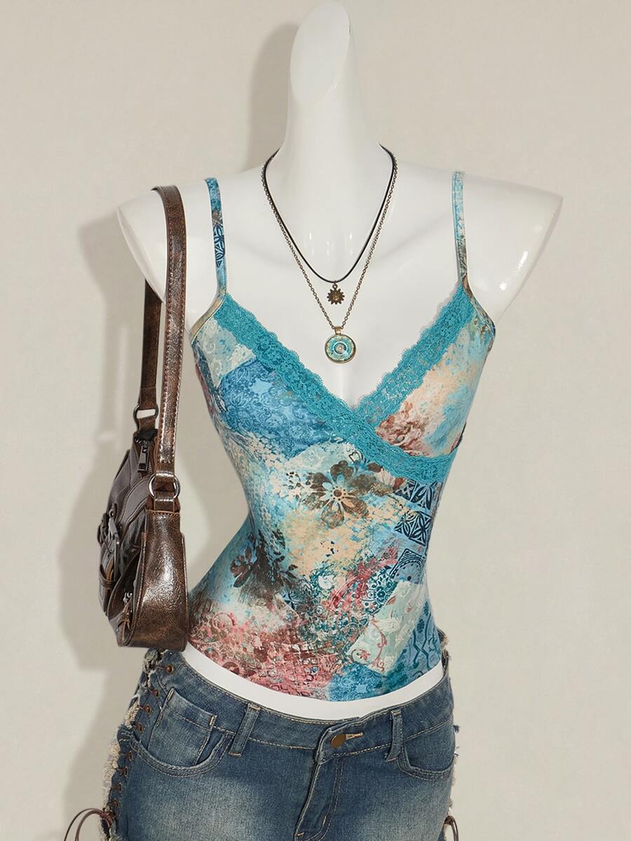 Women's blue fitted camisole top with contrast lace patchwork print, backless asymmetrical hem, and spaghetti straps.