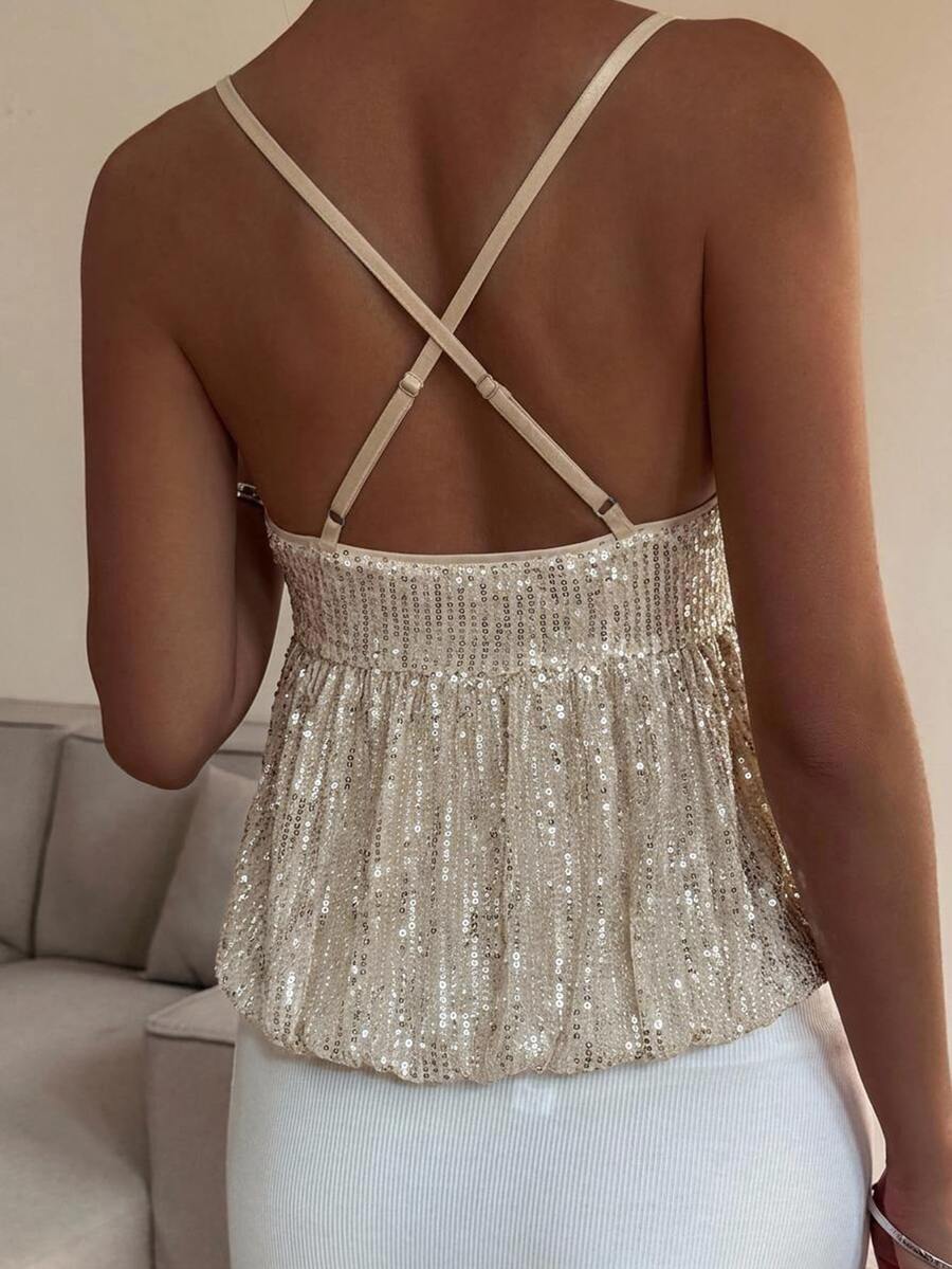Burgundy sequin spaghetti strap cami top featuring a backless design and flared ruffle hem.