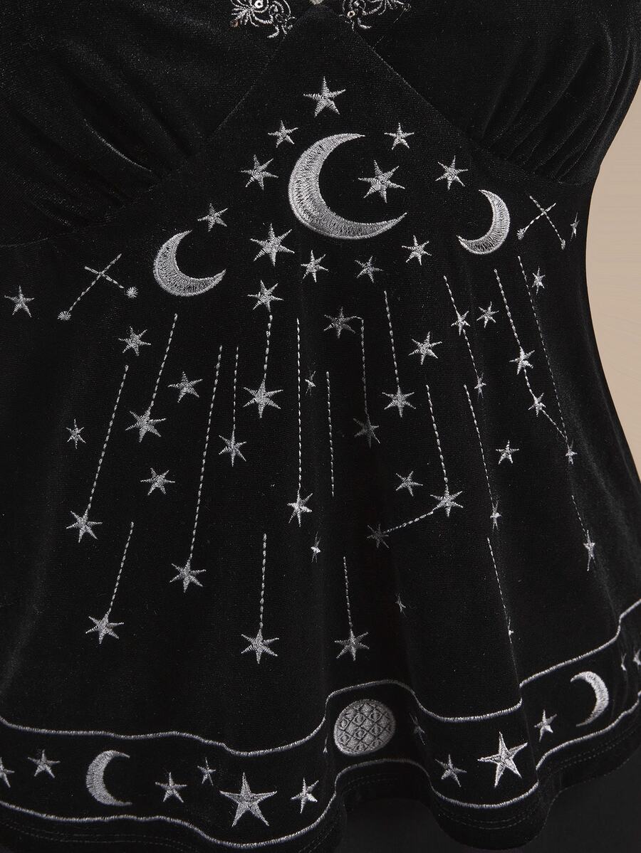 Black velvet camisole top featuring an astrology moon and star graphic print, spaghetti straps, and a backless lace-up design.