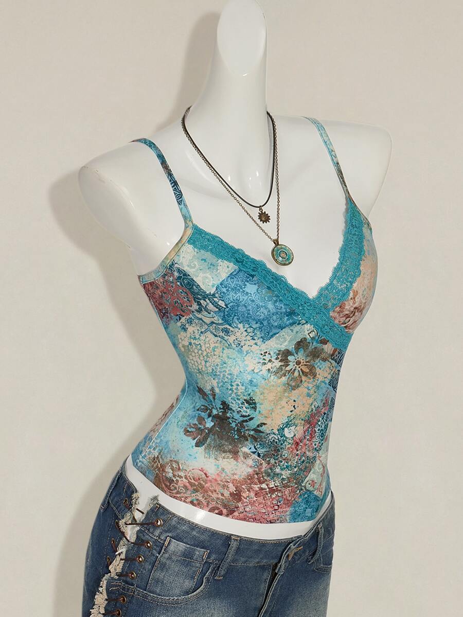 Women's blue fitted camisole top with contrast lace patchwork print, backless asymmetrical hem, and spaghetti straps.