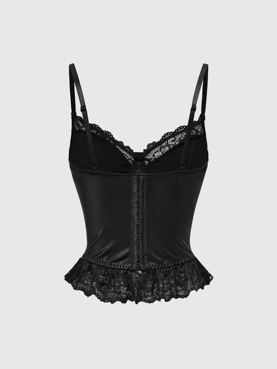 Woman wearing a black gothic micro crop camisole top featuring contrast lace trim, front lace-up detail, ruffle hem, and spaghetti straps.