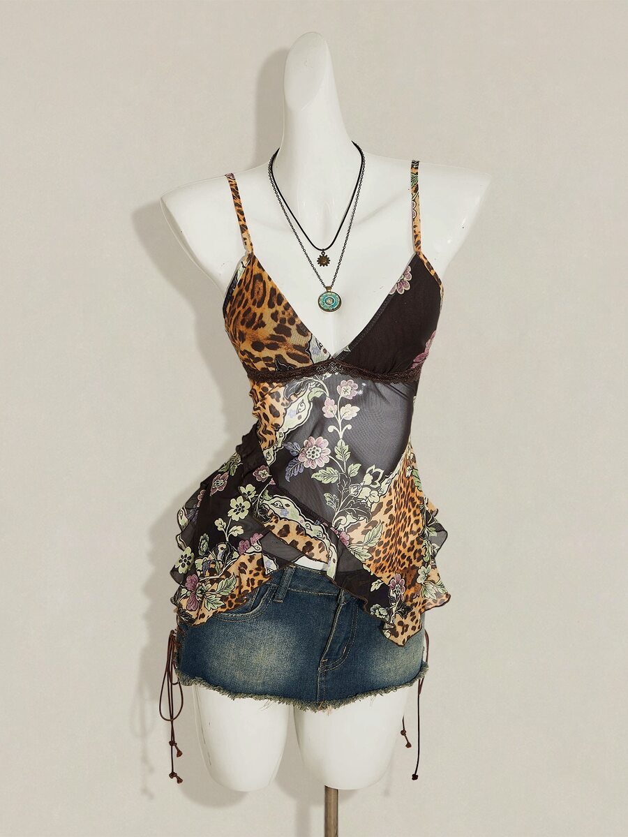 Women's burgundy floral graphic print mesh camisole top featuring an asymmetrical hem, backless cut, and spaghetti straps.