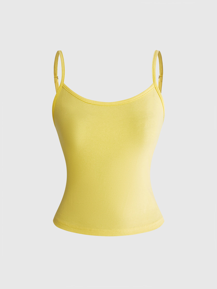 Woman wearing a black backless halter tank top with criss-cross details and textured knit fabric