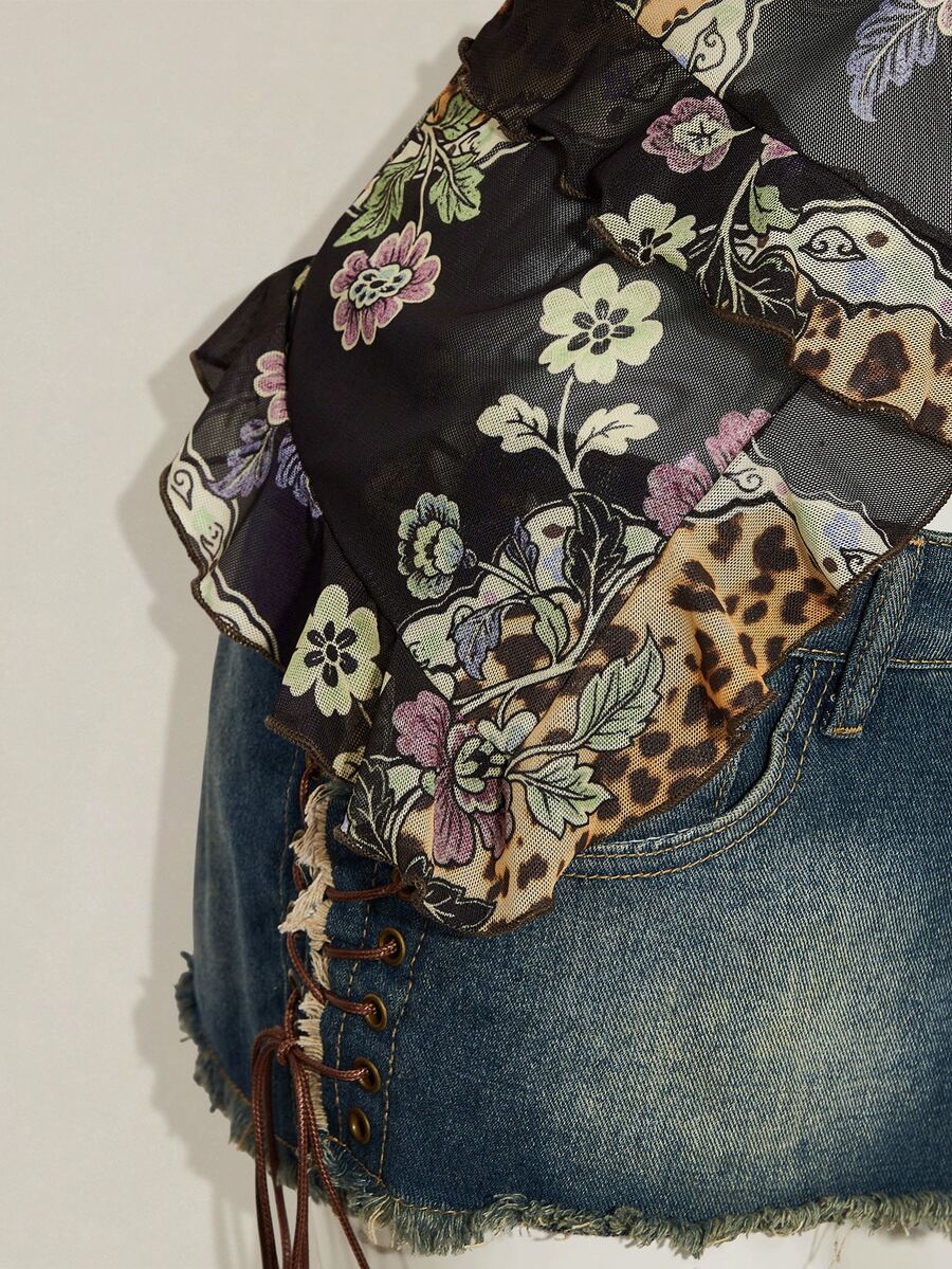 Women's burgundy floral graphic print mesh camisole top featuring an asymmetrical hem, backless cut, and spaghetti straps.
