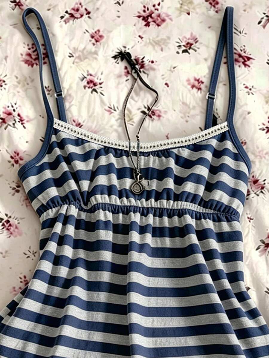 A women's black striped camisole top featuring spaghetti straps, a backless design with ring detail, and high-stretch knitted fabric.
