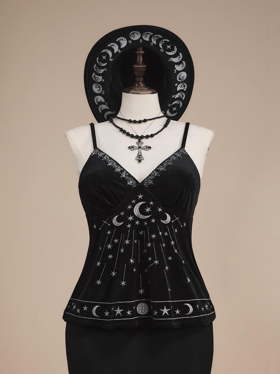 Black velvet camisole top featuring an astrology moon and star graphic print, spaghetti straps, and a backless lace-up design.