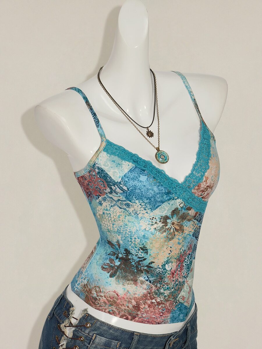 Women's blue fitted camisole top with contrast lace patchwork print, backless asymmetrical hem, and spaghetti straps.