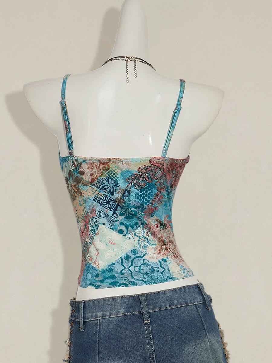 Women's blue fitted camisole top with contrast lace patchwork print, backless asymmetrical hem, and spaghetti straps.
