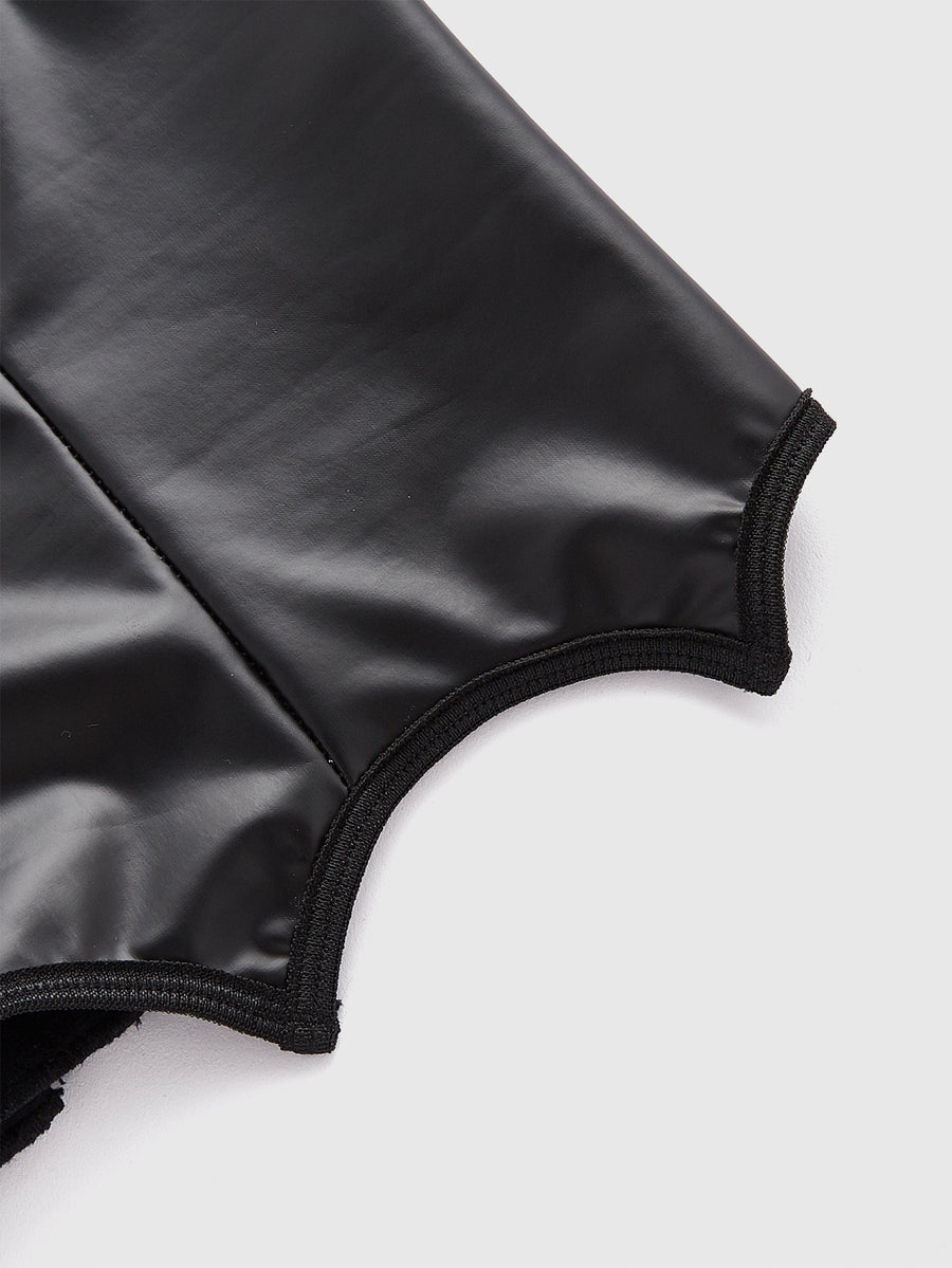 A women's black velvet crop camisole top featuring criss-cross shoulder straps, asymmetrical cut-out details, and a sleeveless vest neckline.