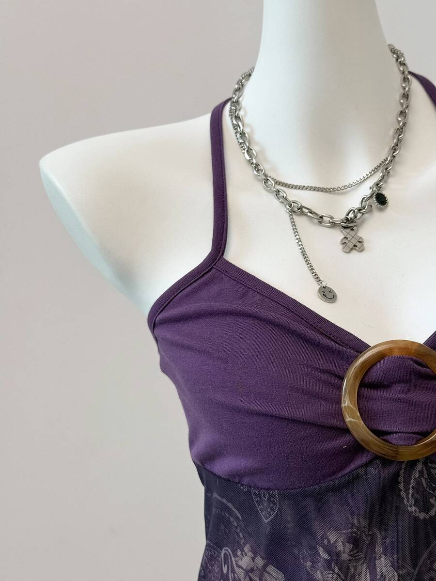 Women's backless halter cami top featuring a paisley print, sleeveless design, and an asymmetrical hem in knitted fabric.