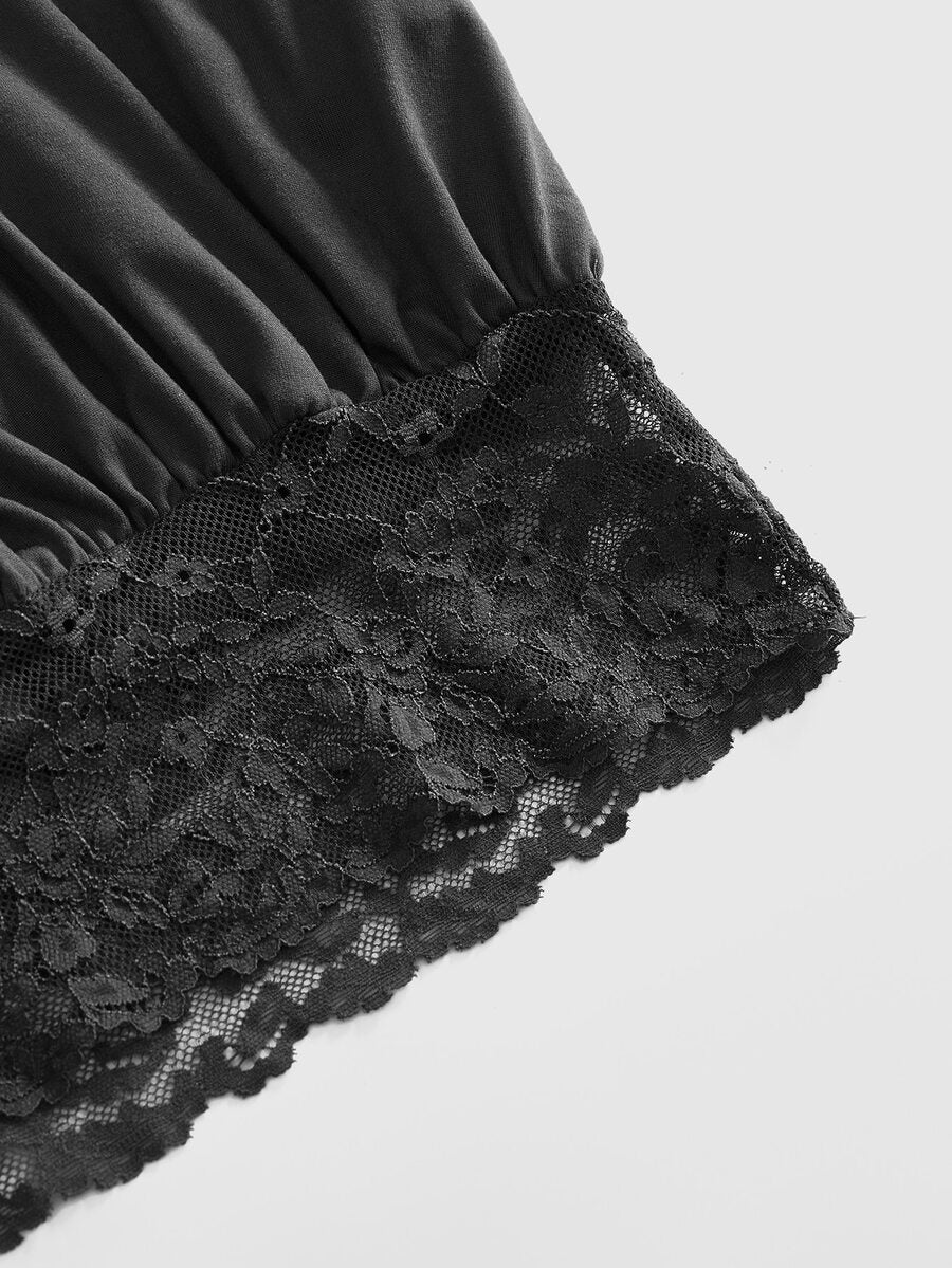 Woman wearing a black slim fit halter camisole crop top with lace-up backless tie detail.