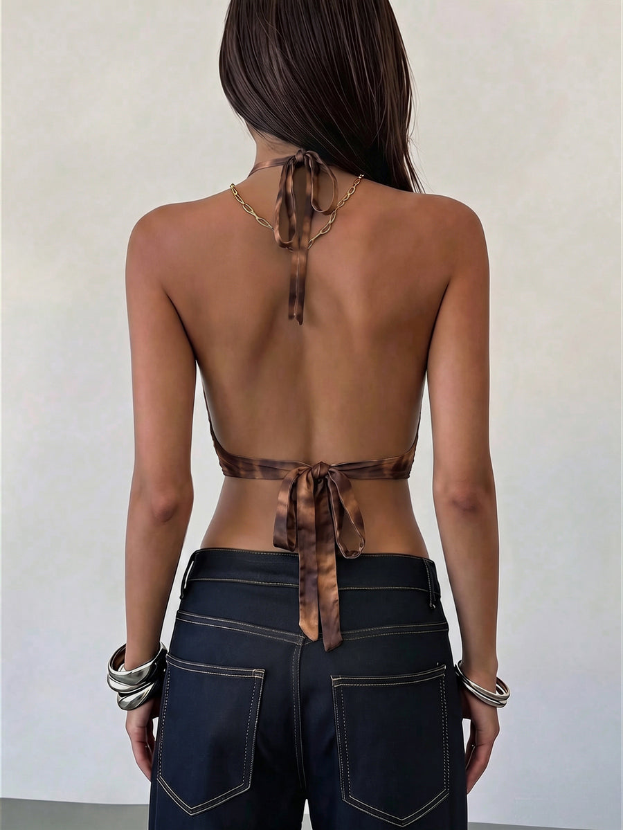 Women's black faux leather backless cami top with spaghetti straps and lace-up shirred sides.