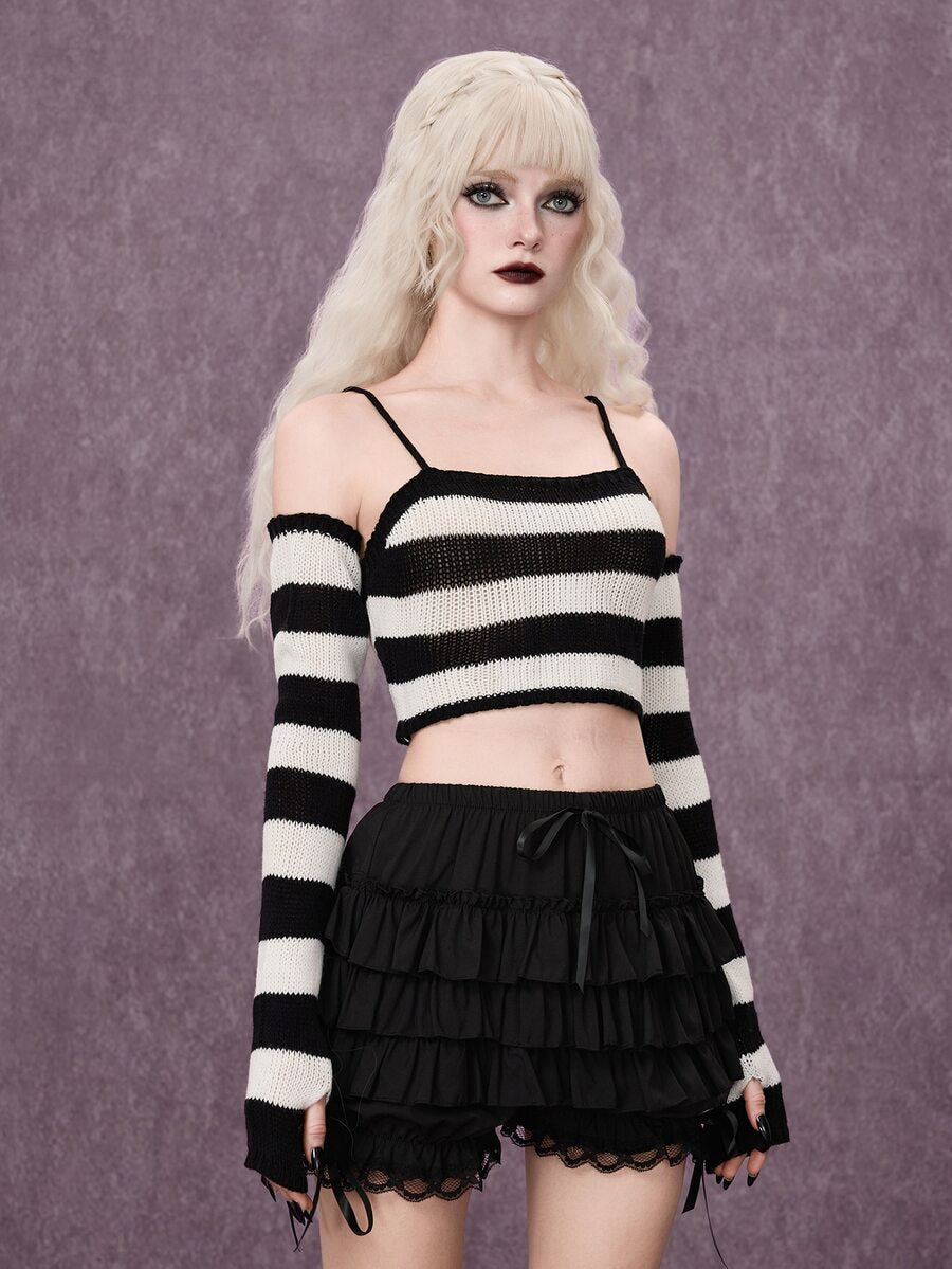 Women wearing a black and white striped camisole knit crop top with spaghetti straps and extra-long cold shoulder sleeves.