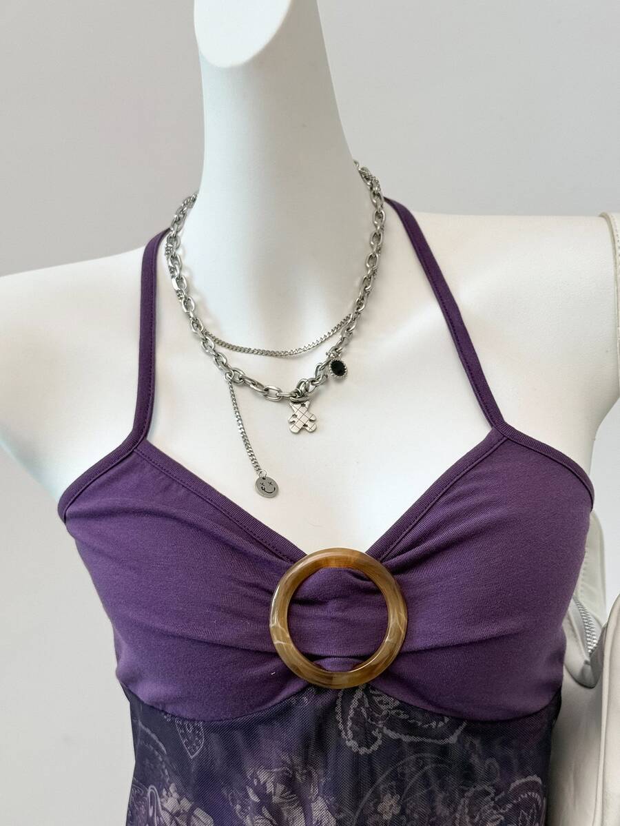 Women's backless halter cami top featuring a paisley print, sleeveless design, and an asymmetrical hem in knitted fabric.