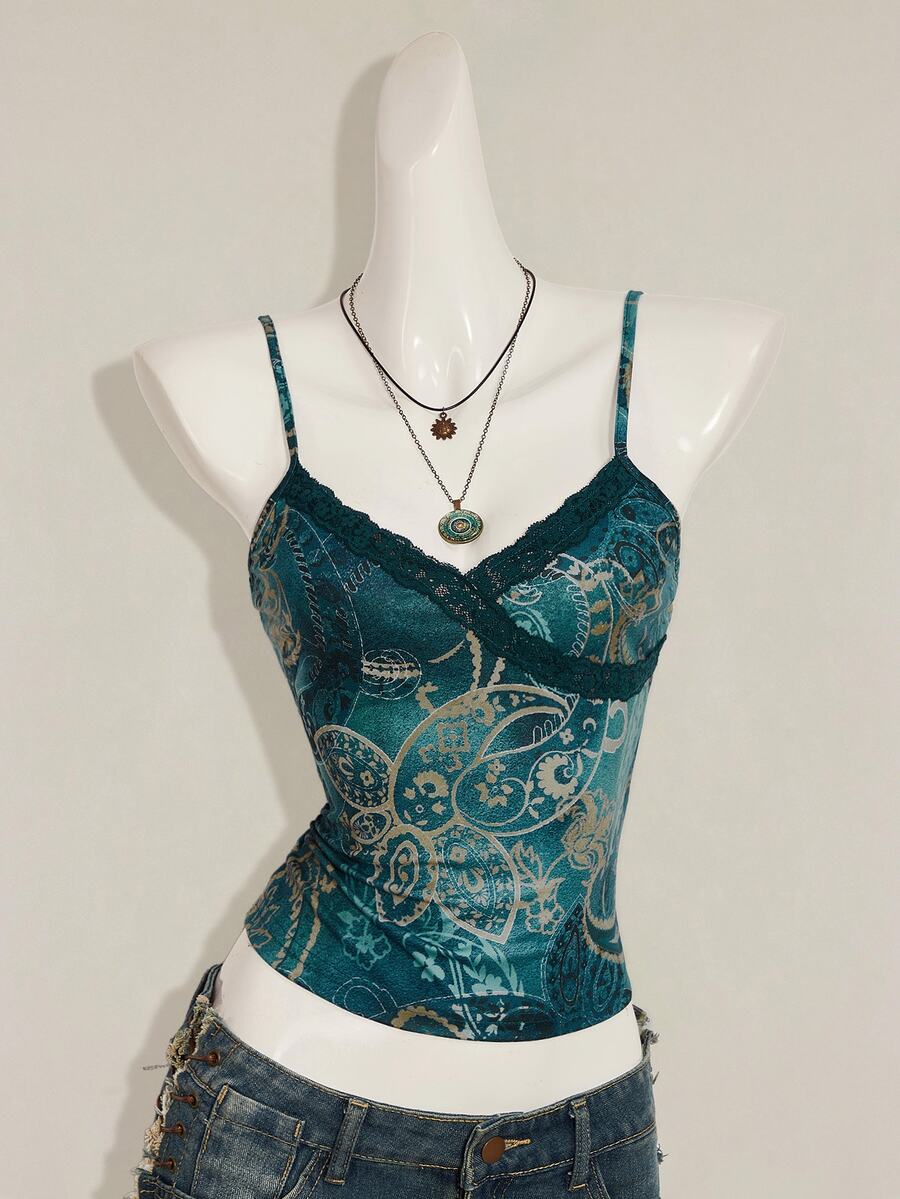 Women's blue fitted camisole top with contrast lace patchwork print, backless asymmetrical hem, and spaghetti straps.