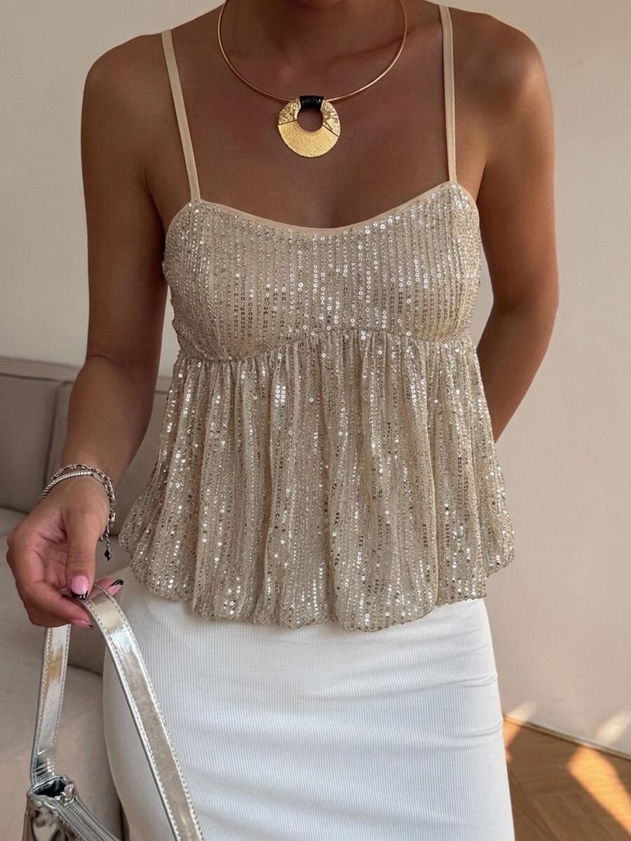 Burgundy sequin spaghetti strap cami top featuring a backless design and flared ruffle hem.